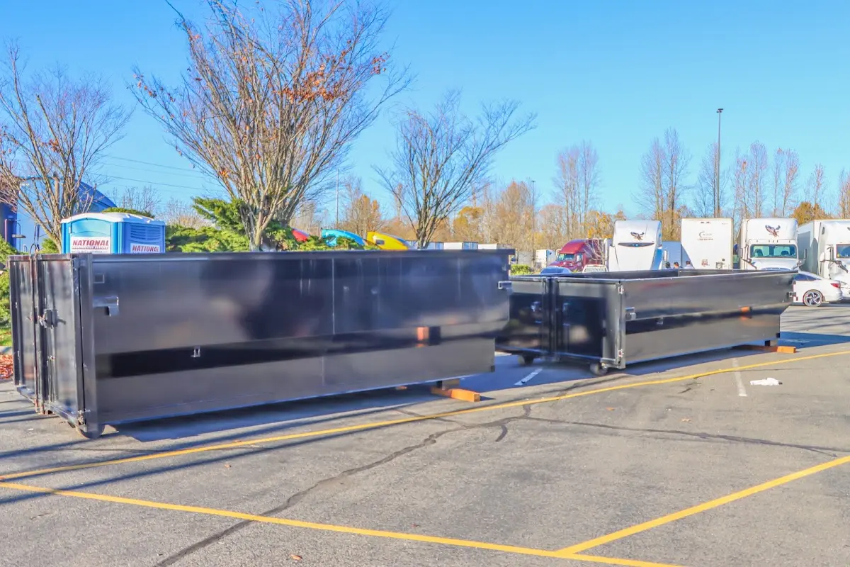 Professional dumpster rental service with roll-off container on residential driveway in Cupertino